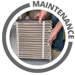 A furnace air filter being replaced during maintenance of home heating equipment. A furnace air filter being replaced during maintenance of home heating equipment.